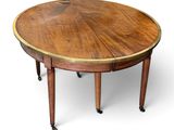 a round table with a wooden top on wheels