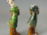 two figurines that are standing next to each other