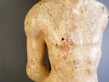 une statue représentant un homme torse nu