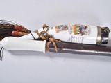 a bottle of wine sitting on top of a wooden stick
