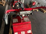 a red machine sitting on a pallet in a warehouse