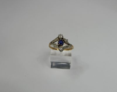a close up of a ring with a blue stone in it