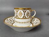 a close up of a cup and saucer on a table
