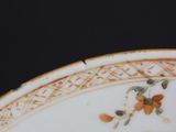 a close up of a plate with a flower design on it