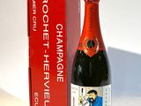 une bouteille de champagne à côté d'un carton de vin