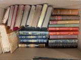 a box full of old books sitting on a table