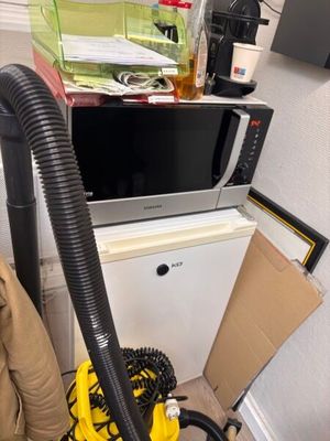a yellow vacuum cleaner sitting on top of a kitchen counter