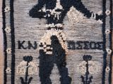 a picture of a rug with a picture of a man holding a gun