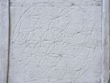 photograph of a white cement block with a square design on it