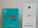 two boxes of perfume sitting next to each other on a table