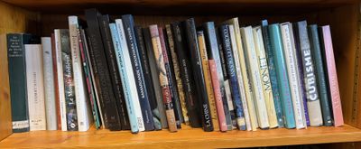 many books on a wooden shelf in a library
