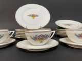 five cups and a saucer on the table