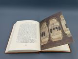 an open book with a picture of a building on it