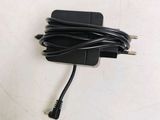 a black charger that is plugged into the wall