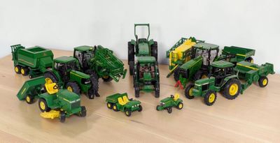 a lot of toy tractors that are sitting on a table