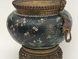 a large vase with a bird on it on a stand
