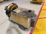 a cart that has a hose on it in a warehouse