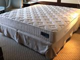 a bed that has a mattress on it in a room