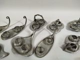 five spoons and two spoon holders on a white surface
