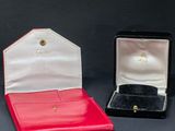 two red and white boxes with a gold ring inside of them