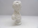 a white marble bust of a young boy on a glass stand