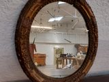 a mirror that is sitting on a shelf in a room