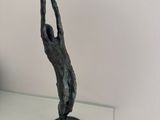 a statue of a man holding a bowl on his head