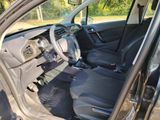 the interior of a car with the door open and a steering wheel in it