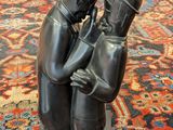 an image of a statue of a man and woman kissing on a rug