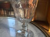 a wine glass sitting on top of a marble table