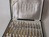 a black case with silverware in it on a white surface