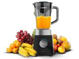 un mixeur posé à côté d'un panier de fruits