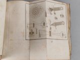 an open book with drawings on it on a table