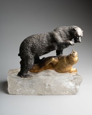 statue of a bear and a cat on a rock on a gray background