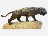 statue of a lion on a rock on a white background