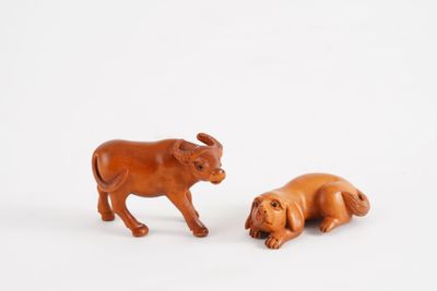 pair of wooden figurines of a bull and a dog