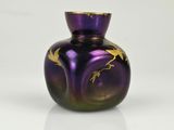 a purple glass vase with gold birds on it