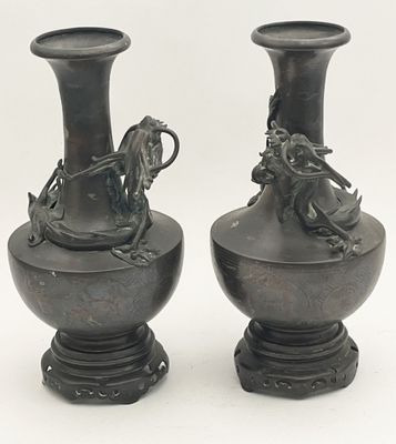 two vases that are sitting next to each other on a table