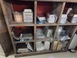 a wooden shelf with many containers and containers on it