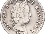 an old silver coin with a bust of a man on it