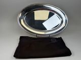 a silver plate with a mirror on top of it