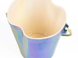 a blue and purple bowl with handles on a white background