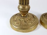 pair of antique brass candlesticks on a white background