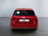 the rear end of a red car in a white room