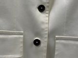 white dress shirt with black buttons on the collar and cuffs