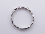 an image of a ring made of silver and black stones