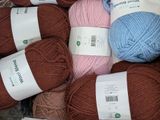 many balls of yarn sitting in a basket together