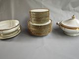 a white and gold tea set on a table