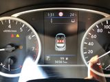 dashboard view of a car with a speedometer, gauges, and other instruments