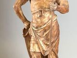 a statue of a man holding a sword and a dog